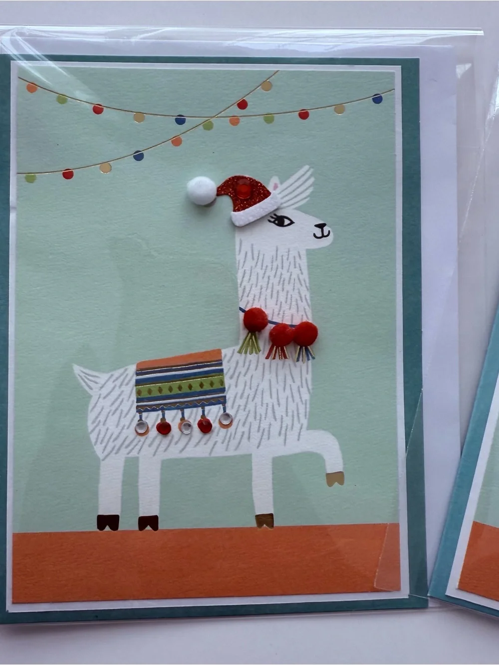Llama Holiday Card - featuring an adorned “ticas” necklace & “aretes” blanket.